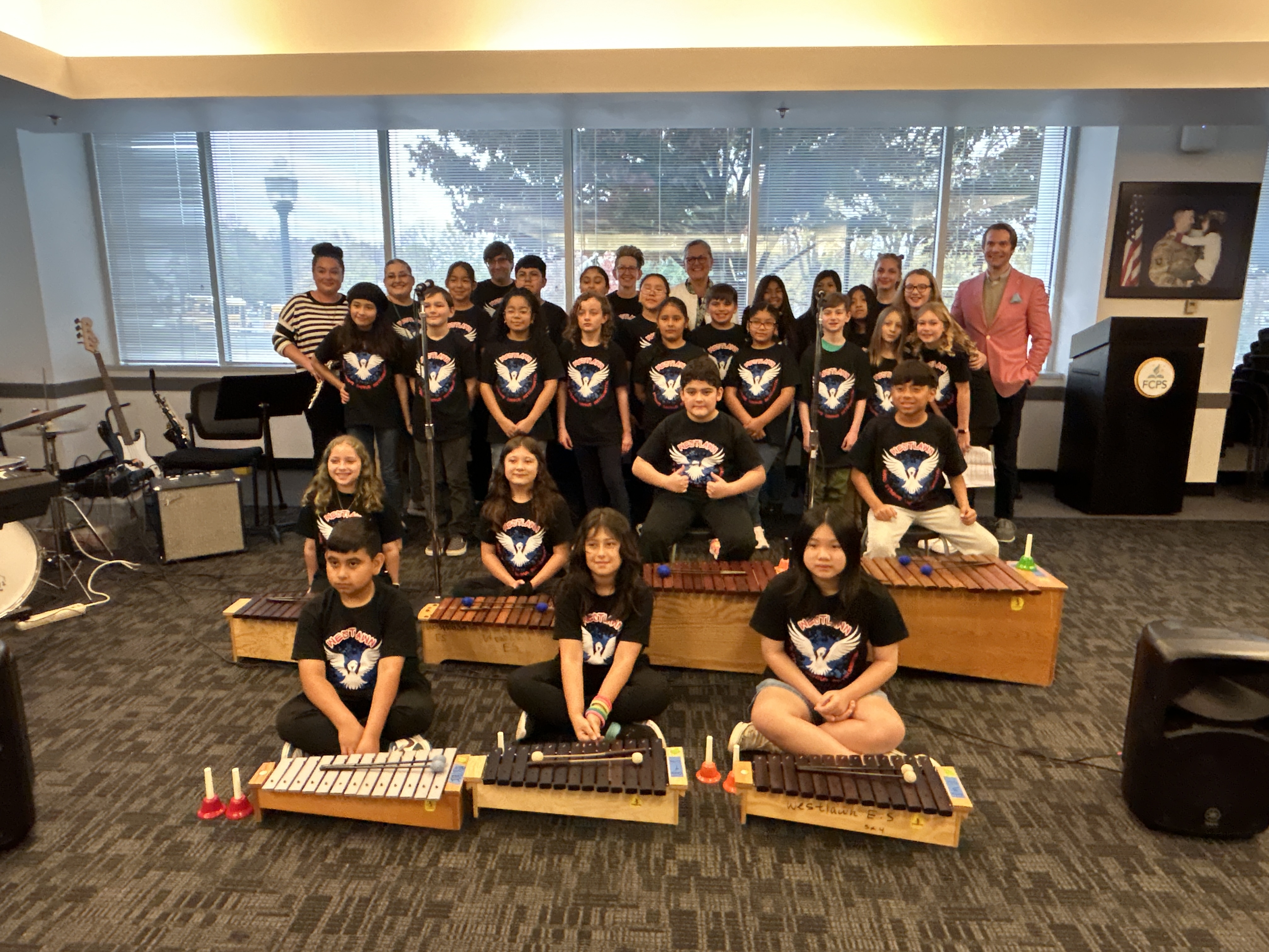 group photo of the performers with the Superintendent at Gatehouse