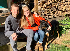 Photo of Mrs. Lambert, her husband, and their dogs