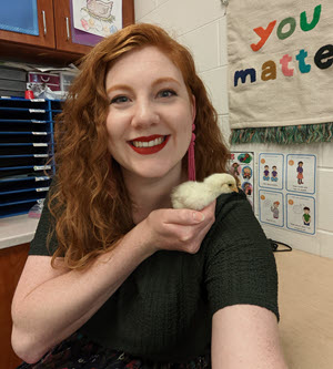 Portrait of Ms. Tolbert holding a baby chick