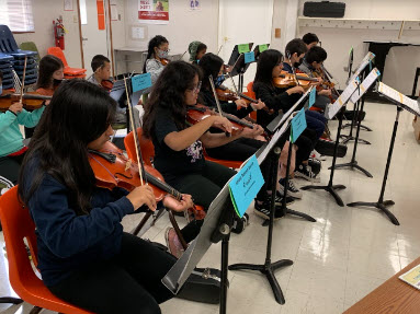 Students practicing strings instruments