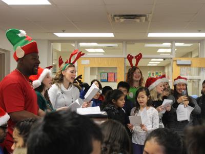 Students join the Staff and have a great time caroling, too.