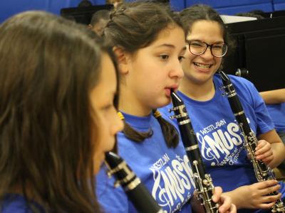 3 girls play clarinets - one smile wide