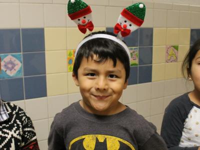 A student with holiday bunny ears