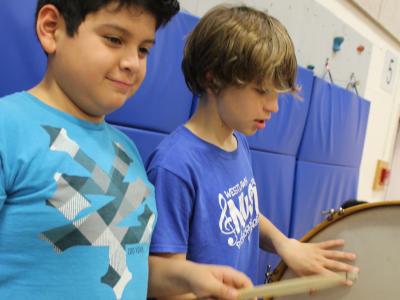 2 boys playing drums