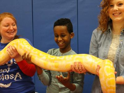 Librarian, student and Kinder teacher hold python