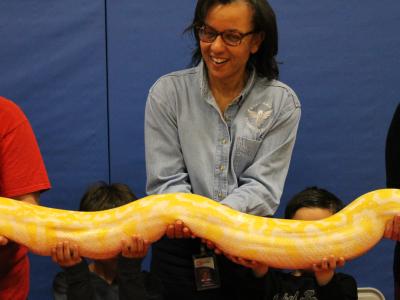 Ms. Ferguson laughs as she holds python