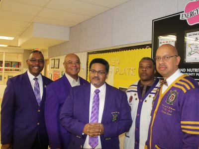 Omega Psi Phi fraternity representatives in purple gowns
