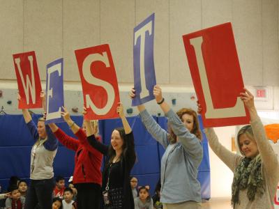 Teachers hold "Westl" signs