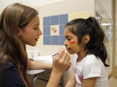 Grade 6 student paints girl's face