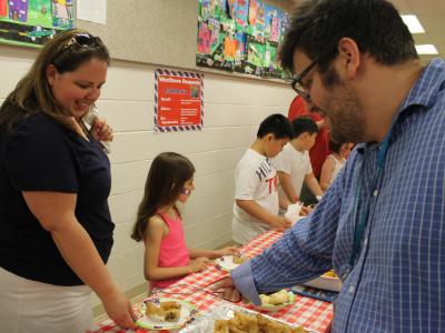 Special Ed teacher and PTA president at the food table