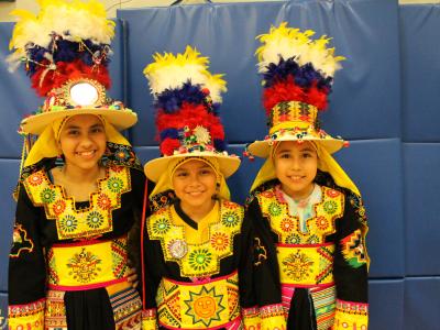 Three students in hispanic costumes