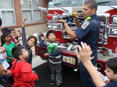 Firefighter talking to students