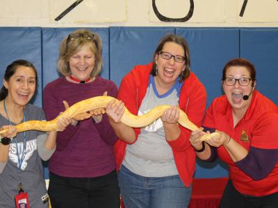Teachers holding snake