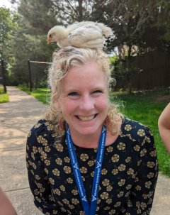 Ms. Carpenter with a baby chick on her head